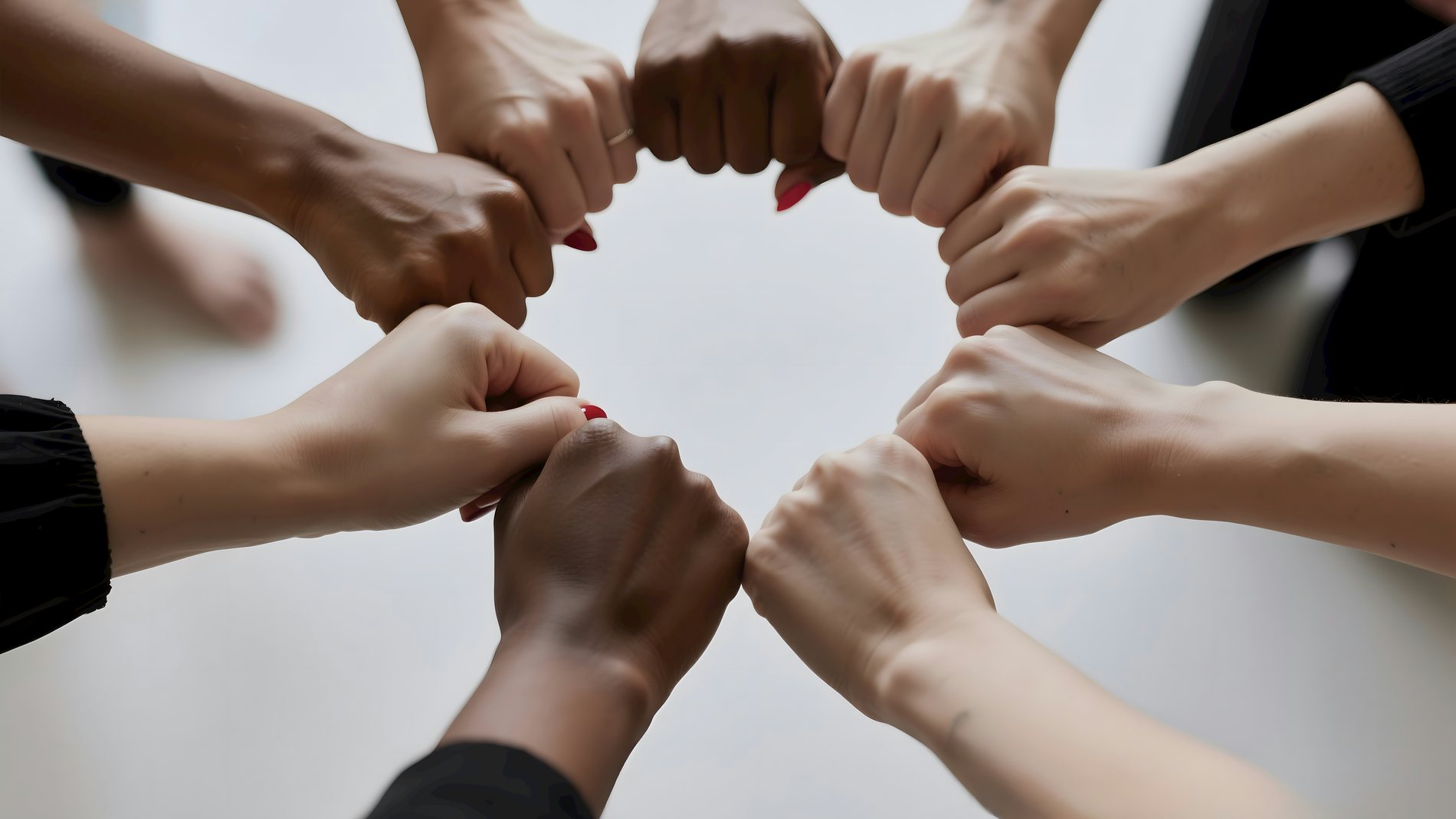 Hands resting together in a circle of mothers